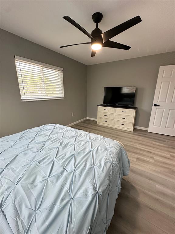 460 Base Avenue East, Unit 129 Venice, FL 34285 - Photo 11 of 33 a bedroom with a bed and a flat screen tv