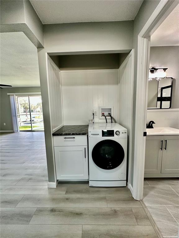 460 Base Avenue East, Unit 129 Venice, FL 34285 - Photo 13 of 33 a view of a kitchen with a sink and a refrigerator
