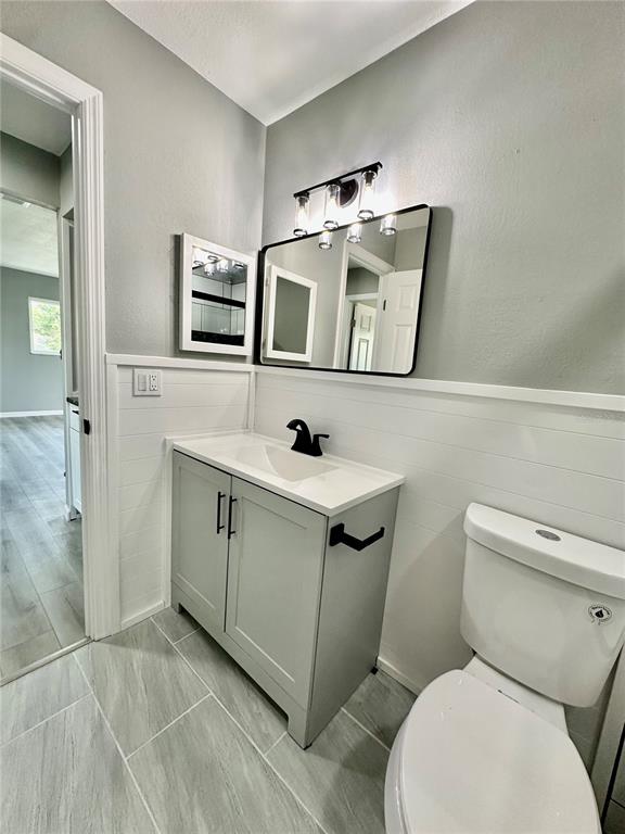 460 Base Avenue East, Unit 129 Venice, FL 34285 - Photo 17 of 33 a bathroom with a toilet sink and mirror