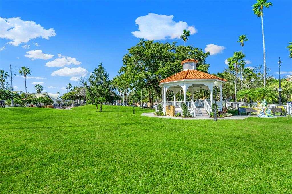 460 Base Avenue East, Unit 129 Venice, FL 34285 - Photo 32 of 33 a view of a house with a yard and sitting area
