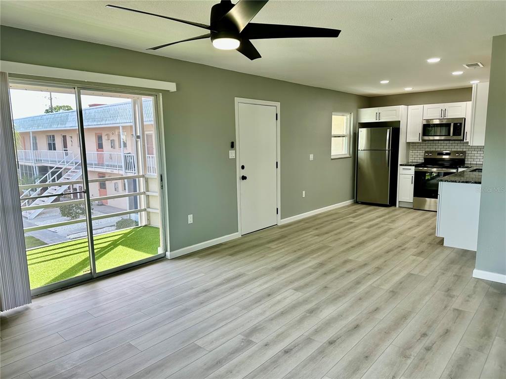 460 Base Avenue East, Unit 129 Venice, FL 34285 - Photo 9 of 33 a view of kitchen with stainless steel appliances wooden floor and window
