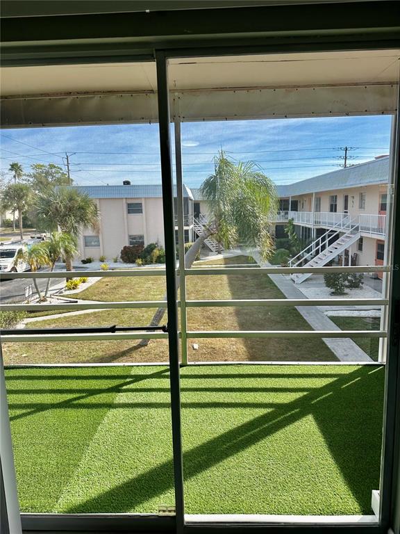 460 Base Avenue East, Unit 129 Venice, FL 34285 - Photo 10 of 33 a view of a swimming pool with a yard and plants