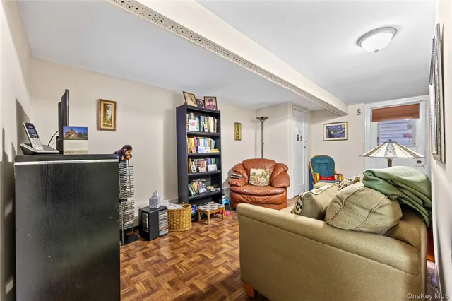 a living room with furniture a rug and a window
