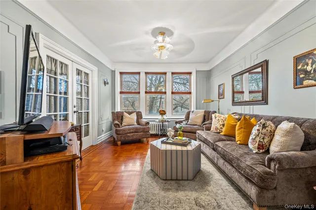 a living room with furniture and a chandelier