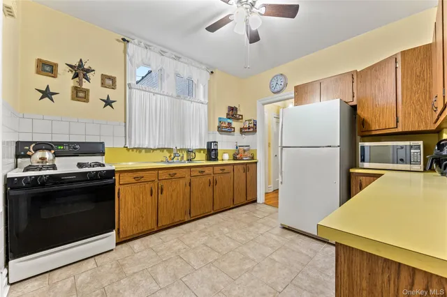 a kitchen with a refrigerator and a stove top oven