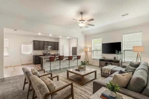 a living room with furniture and a flat screen tv