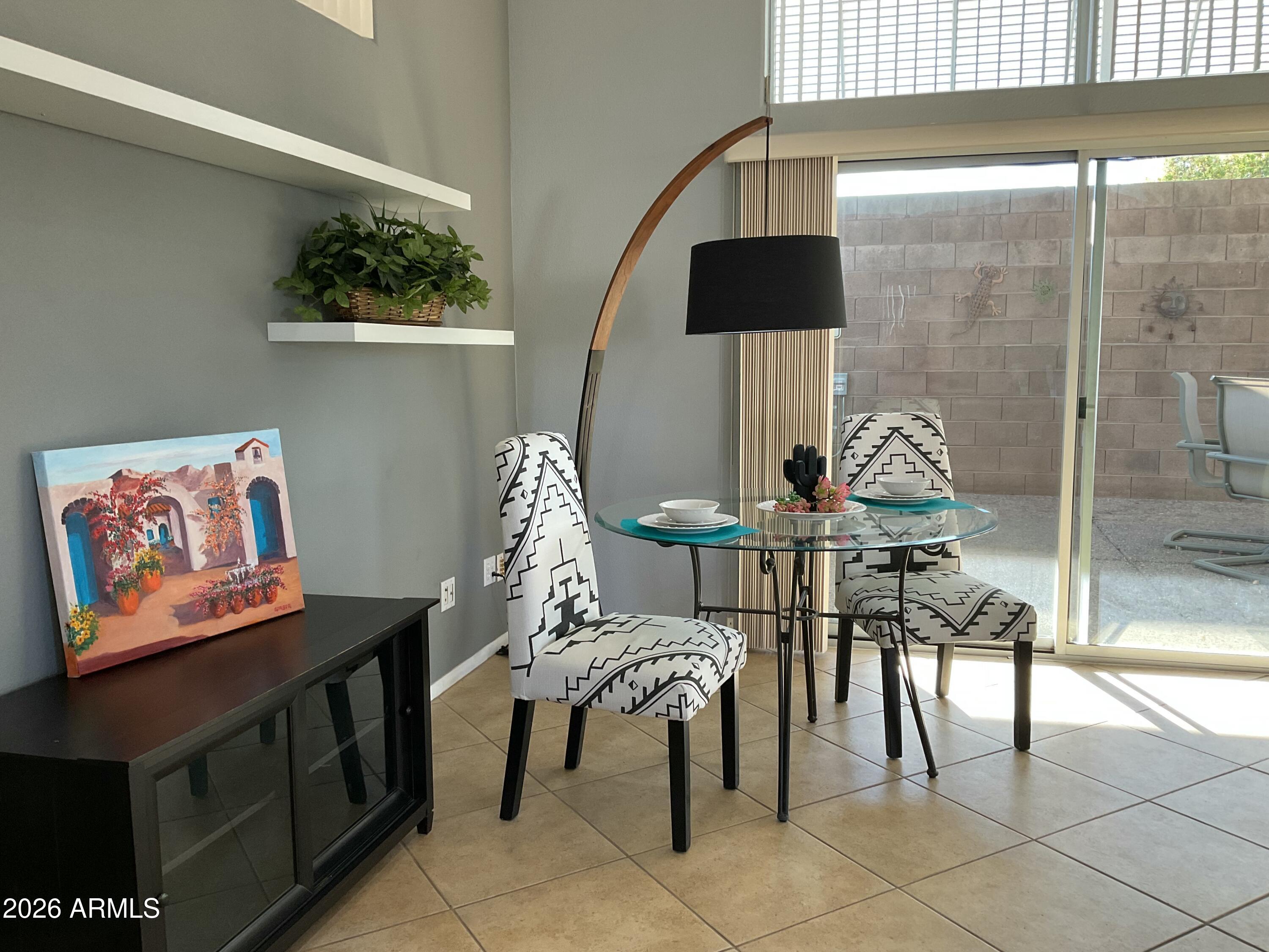 17200 West Bell Road, Unit 1770 Surprise, AZ 85374 - Photo 11 of 36 a view of a dining room with furniture and chandelier