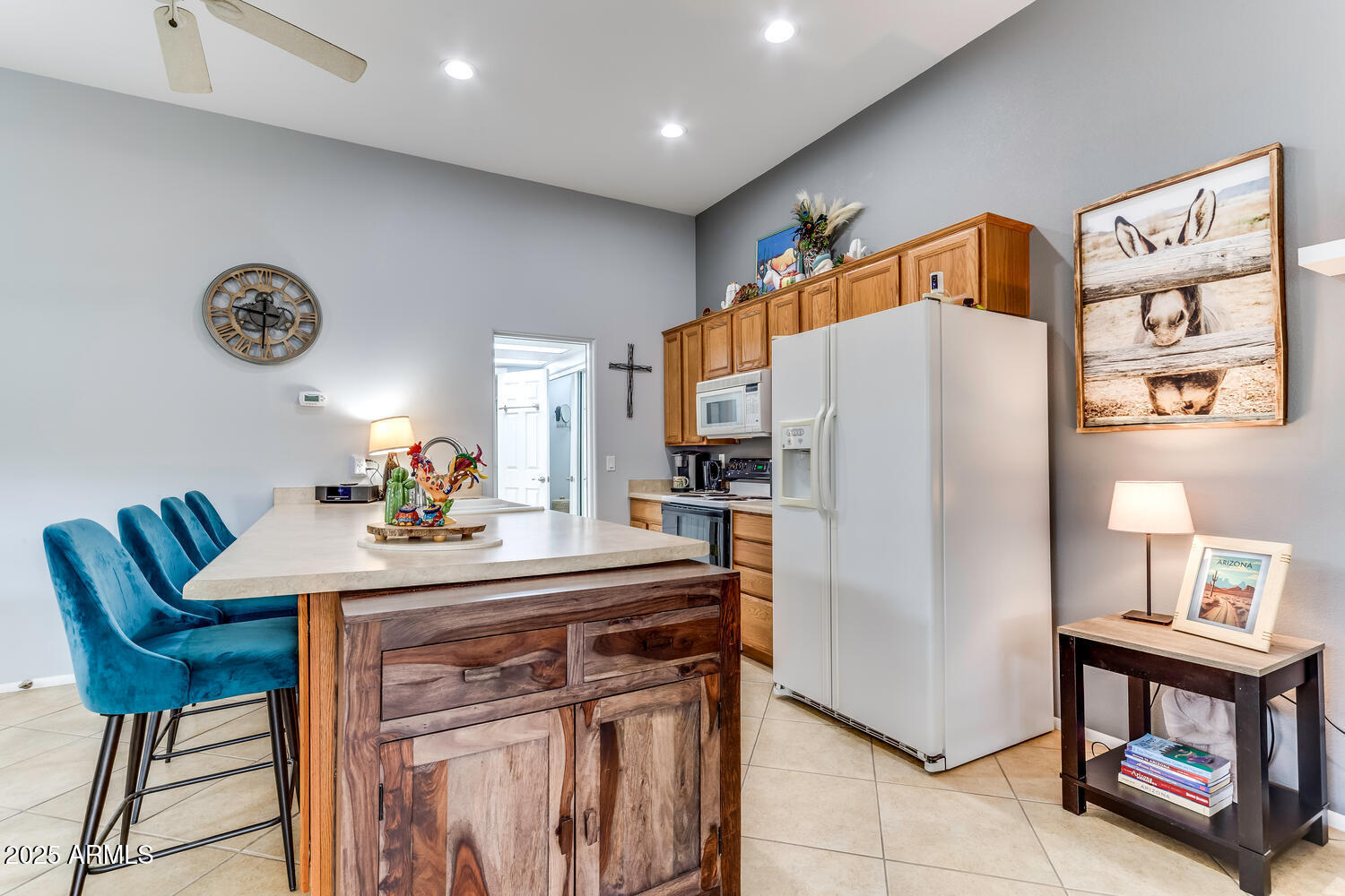 17200 West Bell Road, Unit 1770 Surprise, AZ 85374 - Photo 15 of 36 a kitchen with stainless steel appliances a refrigerator and a dining table