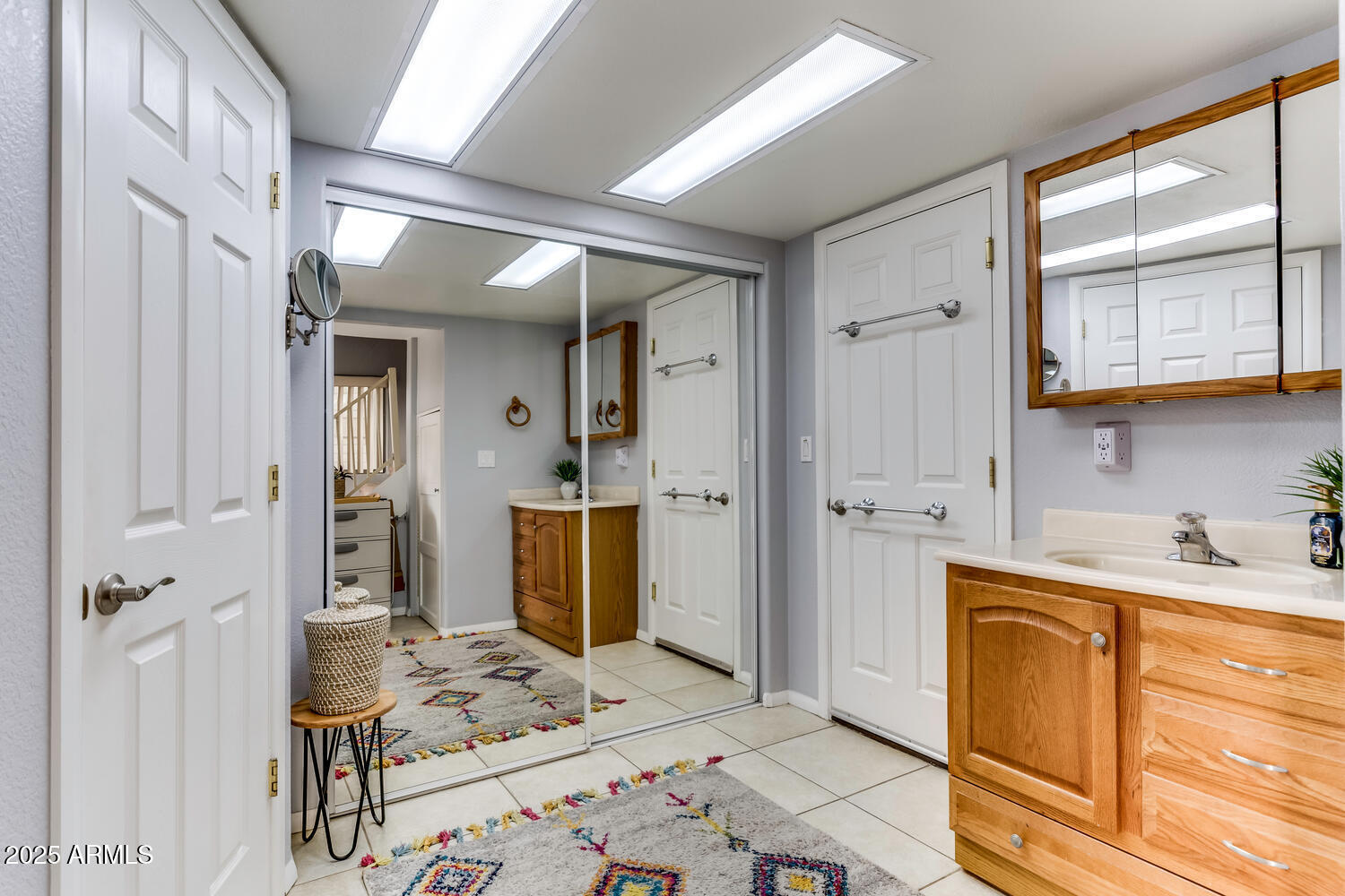 17200 West Bell Road, Unit 1770 Surprise, AZ 85374 - Photo 18 of 36 a bathroom with a sink a mirror and a shower