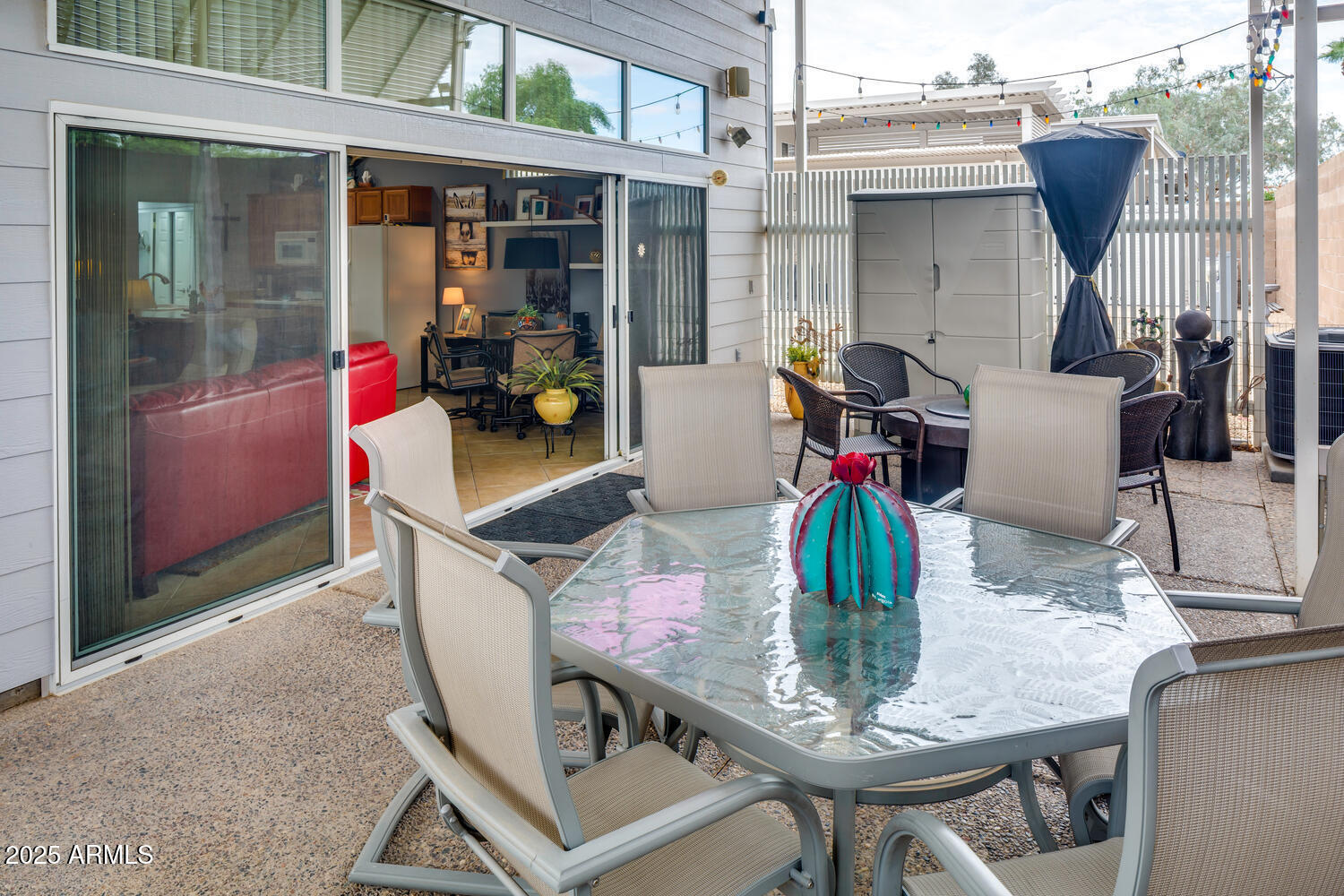 17200 West Bell Road, Unit 1770 Surprise, AZ 85374 - Photo 5 of 36 a view of a dining table and chairs in the patio and a fountain