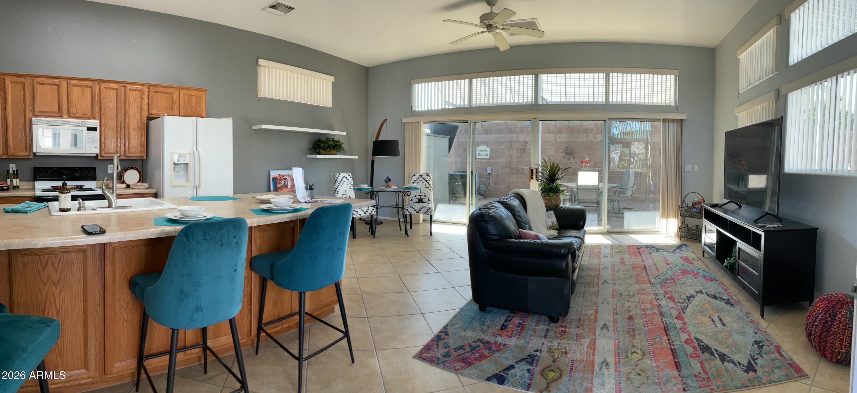 17200 West Bell Road, Unit 1770 Surprise, AZ 85374 - Photo 8 of 36 a living room with furniture and a flat screen tv