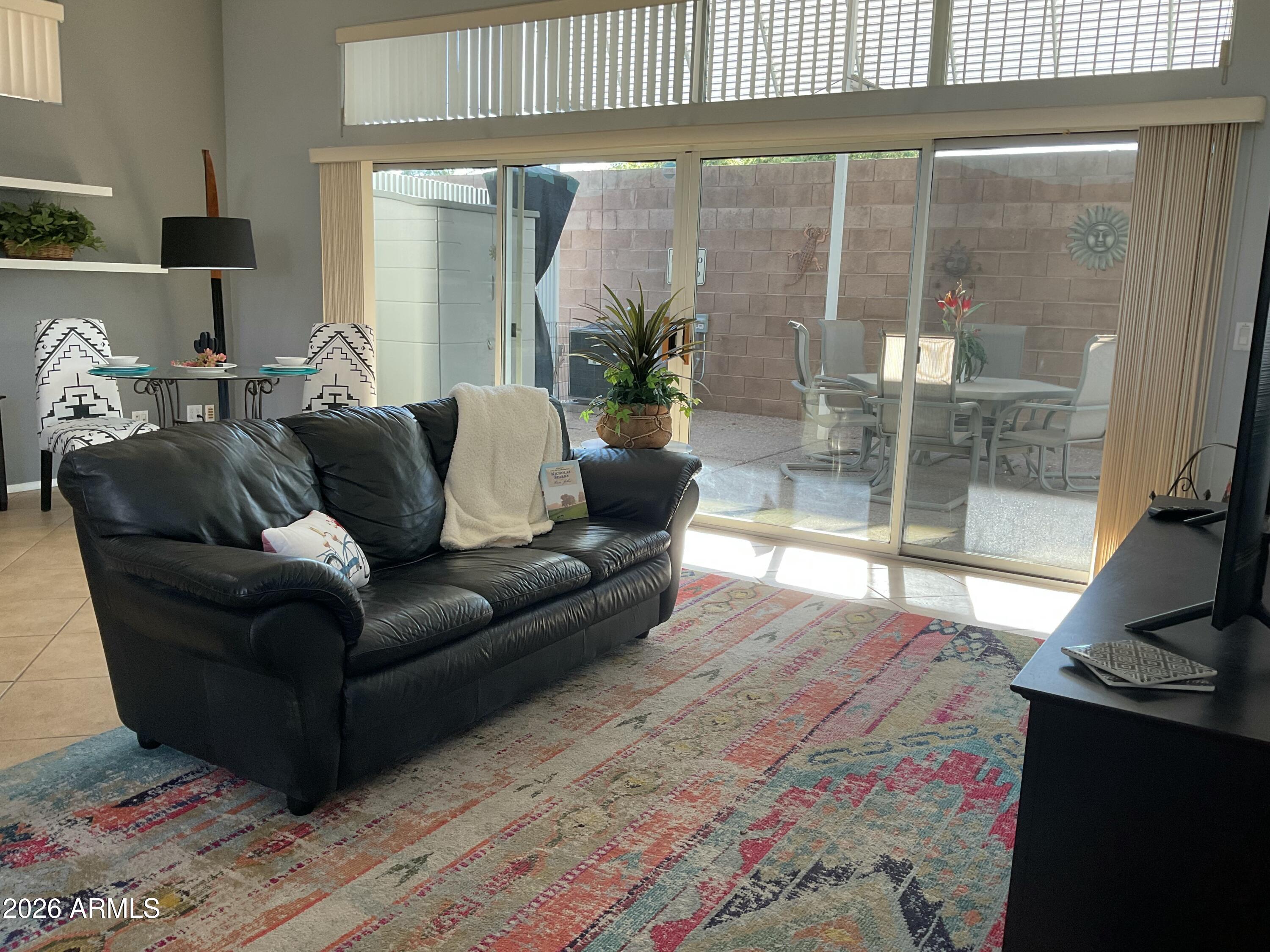 17200 West Bell Road, Unit 1770 Surprise, AZ 85374 - Photo 9 of 36 a living room with furniture and a flat screen tv