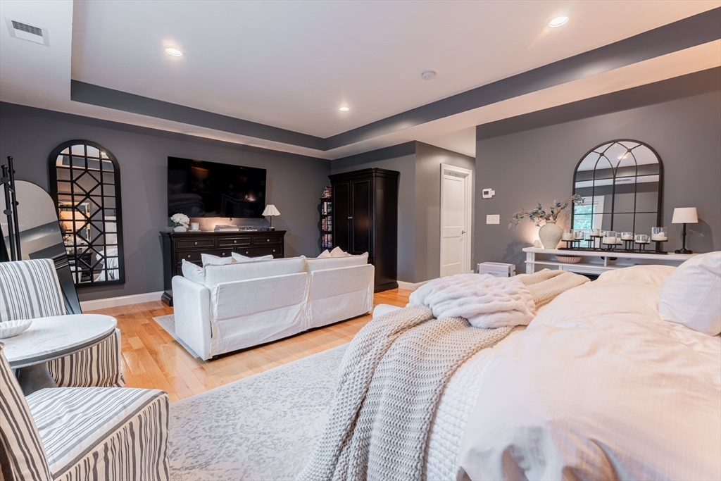 38 Cherry Street, Unit B Hudson, MA 01749 - Photo 22 of 33 a bedroom with a bed and a flat screen tv