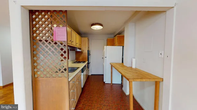 a kitchen with a refrigerator and a stove