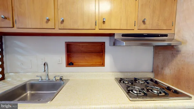 a kitchen with a sink and cabinets