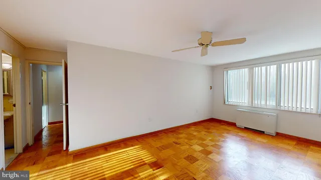 a view of small space with wooden floor and a window