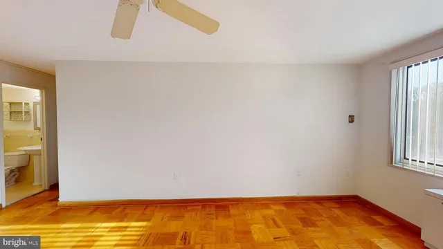 a view of empty room with wooden floor