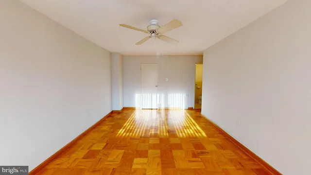 a view of empty room with wooden floor