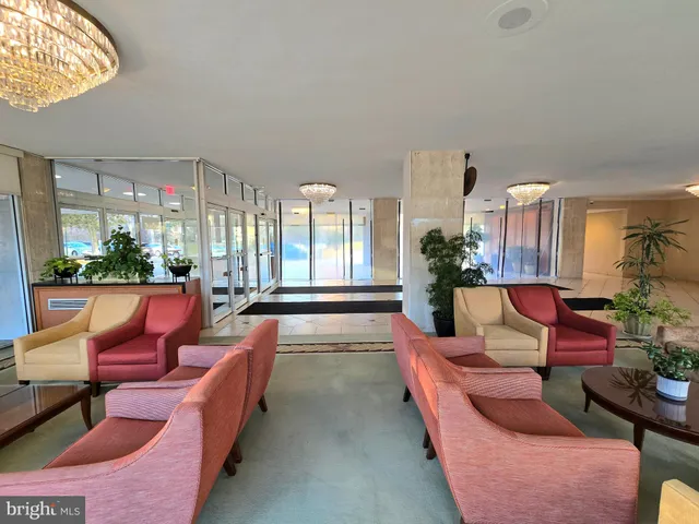 a large living room with patio furniture and a potted plant