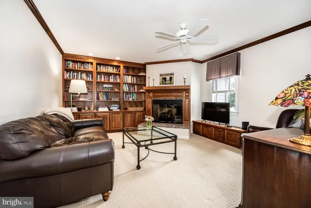 a kitchen with granite countertop a refrigerator oven a sink dishwasher and white cabinets with wooden floor