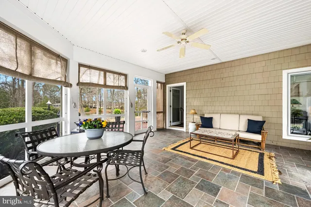 a kitchen with granite countertop a refrigerator oven a sink dishwasher and white cabinets with wooden floor