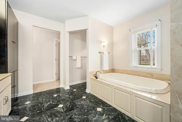a bathroom with a granite countertop sink a toilet a mirror and shower