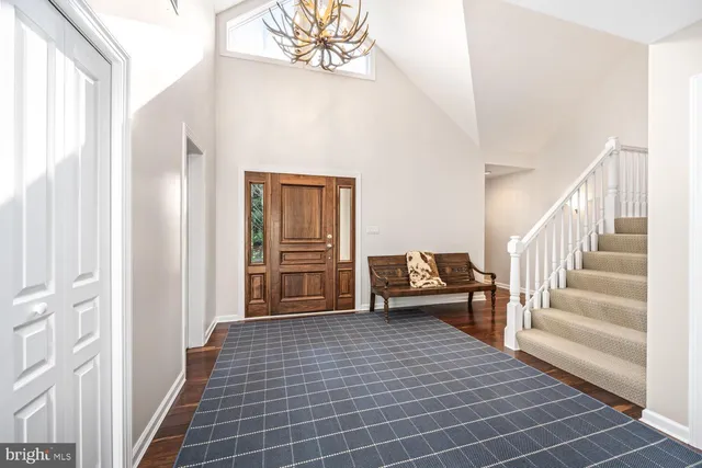 a view of a hallway view with wooden floor and staircase