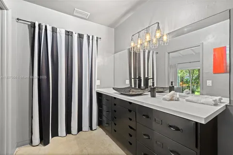 a bathroom with a double vanity sink and a mirror