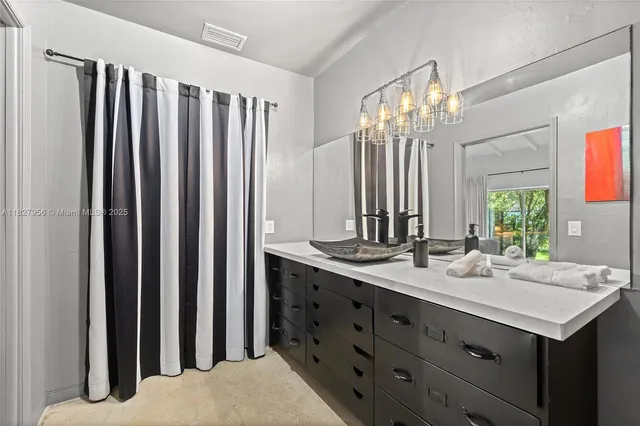 a bathroom with a double vanity sink and a mirror