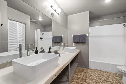 a bathroom with a sink a toilet a mirror and vanity