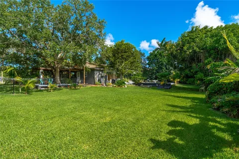a view of house with backyard
