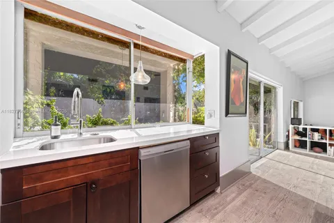 a kitchen with a sink and large window