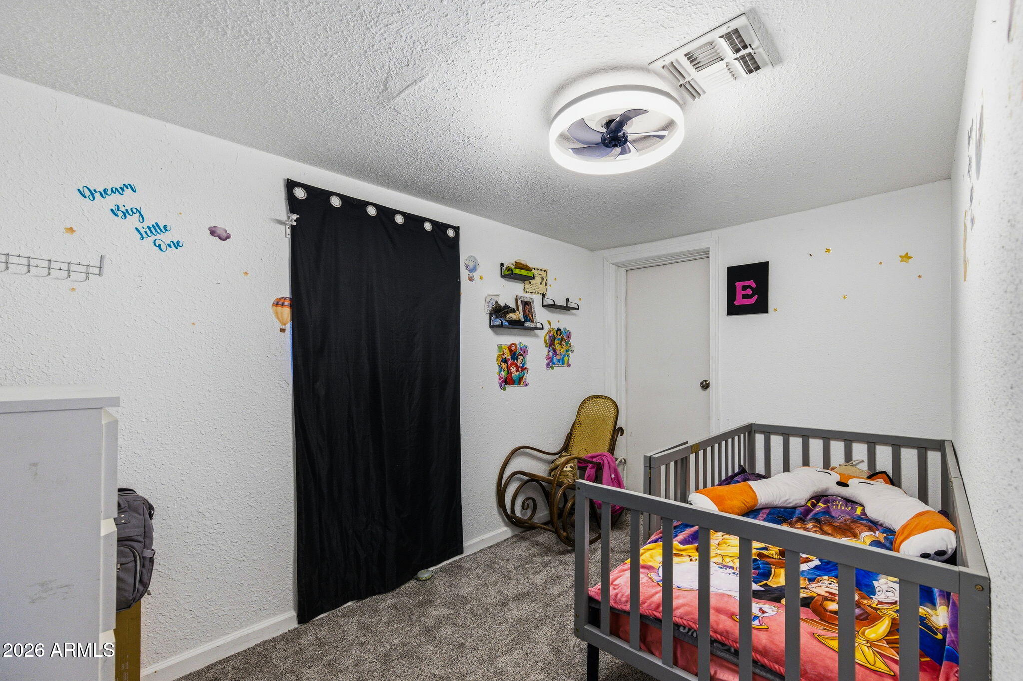 1268 East Rodeo Road Casa Grande, AZ 85122 - Photo 17 of 27 a bedroom with baby bed toys and dresser