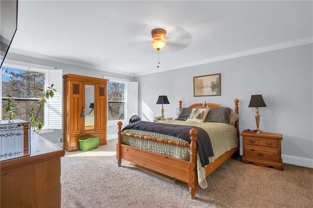 2894 McPherson Road Northeast Roswell, GA 30075 - Photo 11 of 24 a spacious bedroom with a bed and a chandelier