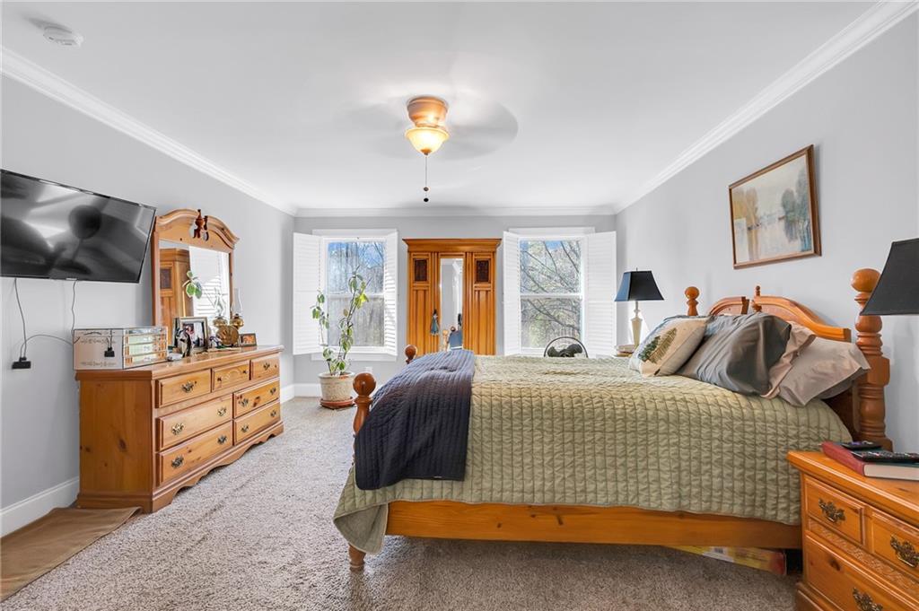 2894 McPherson Road Northeast Roswell, GA 30075 - Photo 12 of 24 a bedroom with a bed and a chandelier