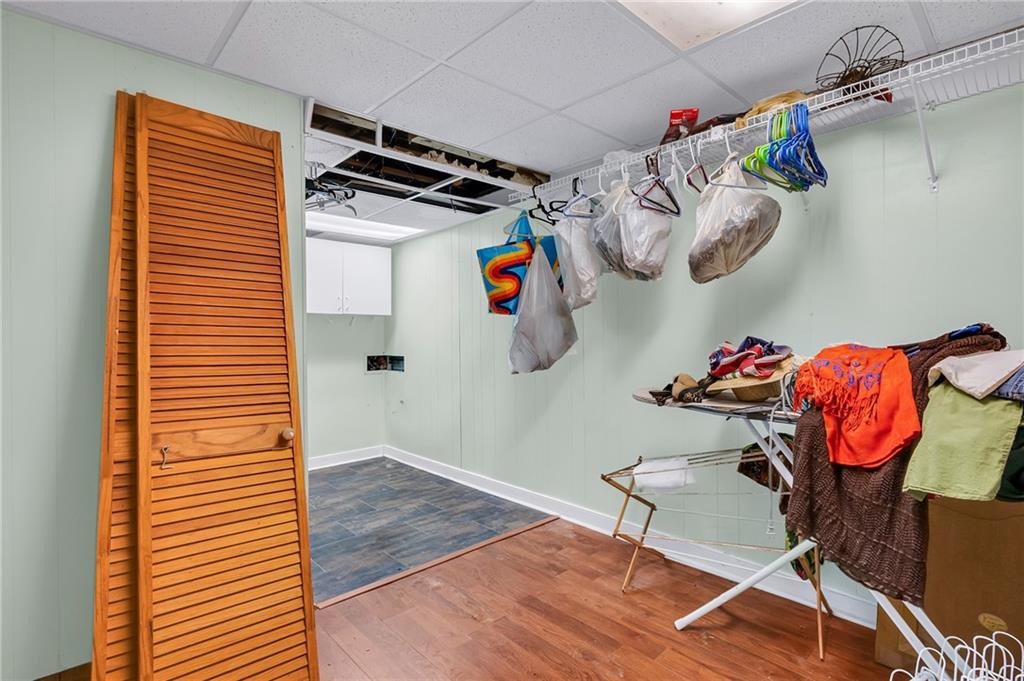 2894 McPherson Road Northeast Roswell, GA 30075 - Photo 19 of 24 a view of walk in closet with clothes and shoes