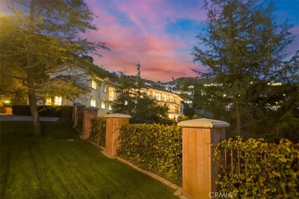 a view of a pathway with a wrought fence