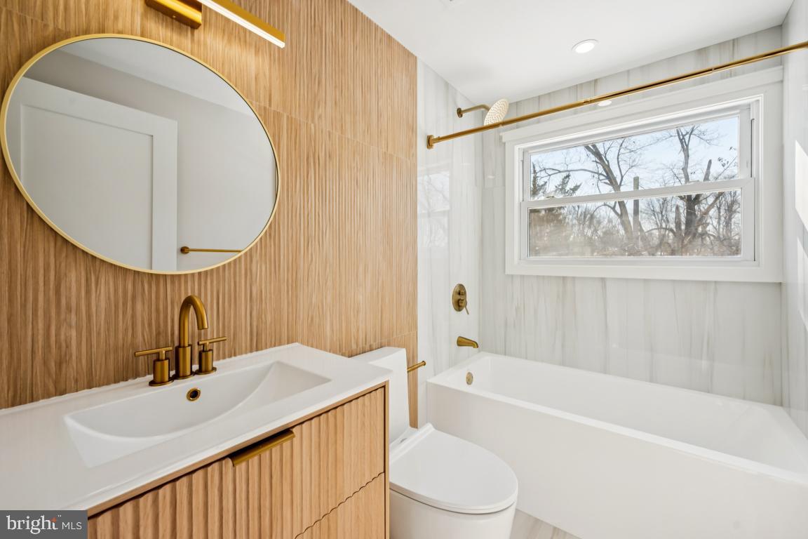 2 Sylvan Lane Willingboro, NJ 08046 - Photo 24 of 26 a bathroom with a bathtub sink vanity mirror and toilet