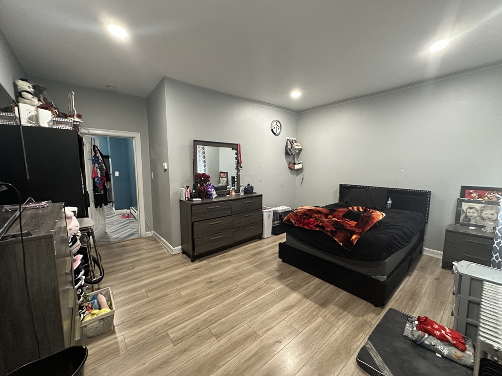 115 Addison Street Chelsea, MA 02150 - Photo 11 of 16 a living room with furniture and a flat screen tv