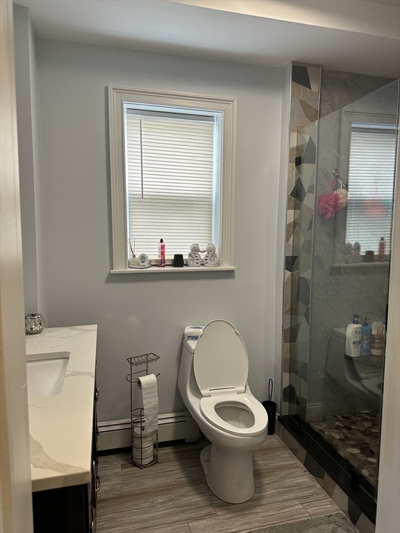 115 Addison Street Chelsea, MA 02150 - Photo 15 of 16 a bathroom with a toilet a sink and a mirror