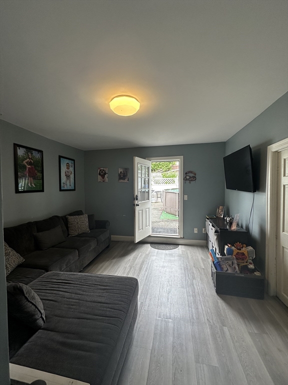 115 Addison Street Chelsea, MA 02150 - Photo 16 of 16 a living room with furniture and a flat screen tv