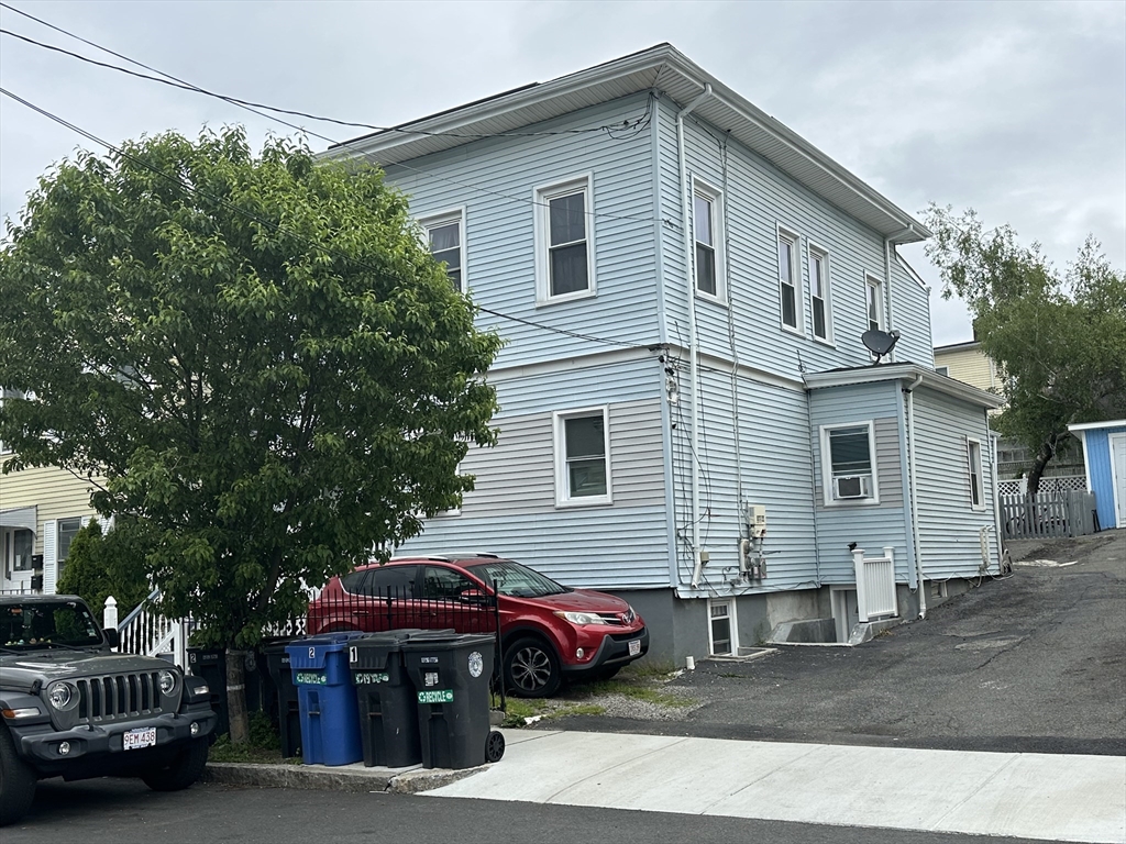 115 Addison Street Chelsea, MA 02150 - Photo 2 of 16 a view of a house and a small yard