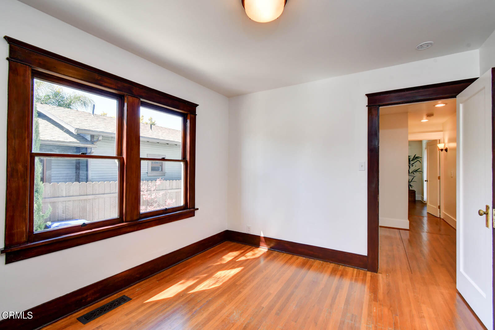 149 Grand Avenue Monrovia, CA 91016 - Photo 21 of 50 a view of an empty room with wooden floor and a window