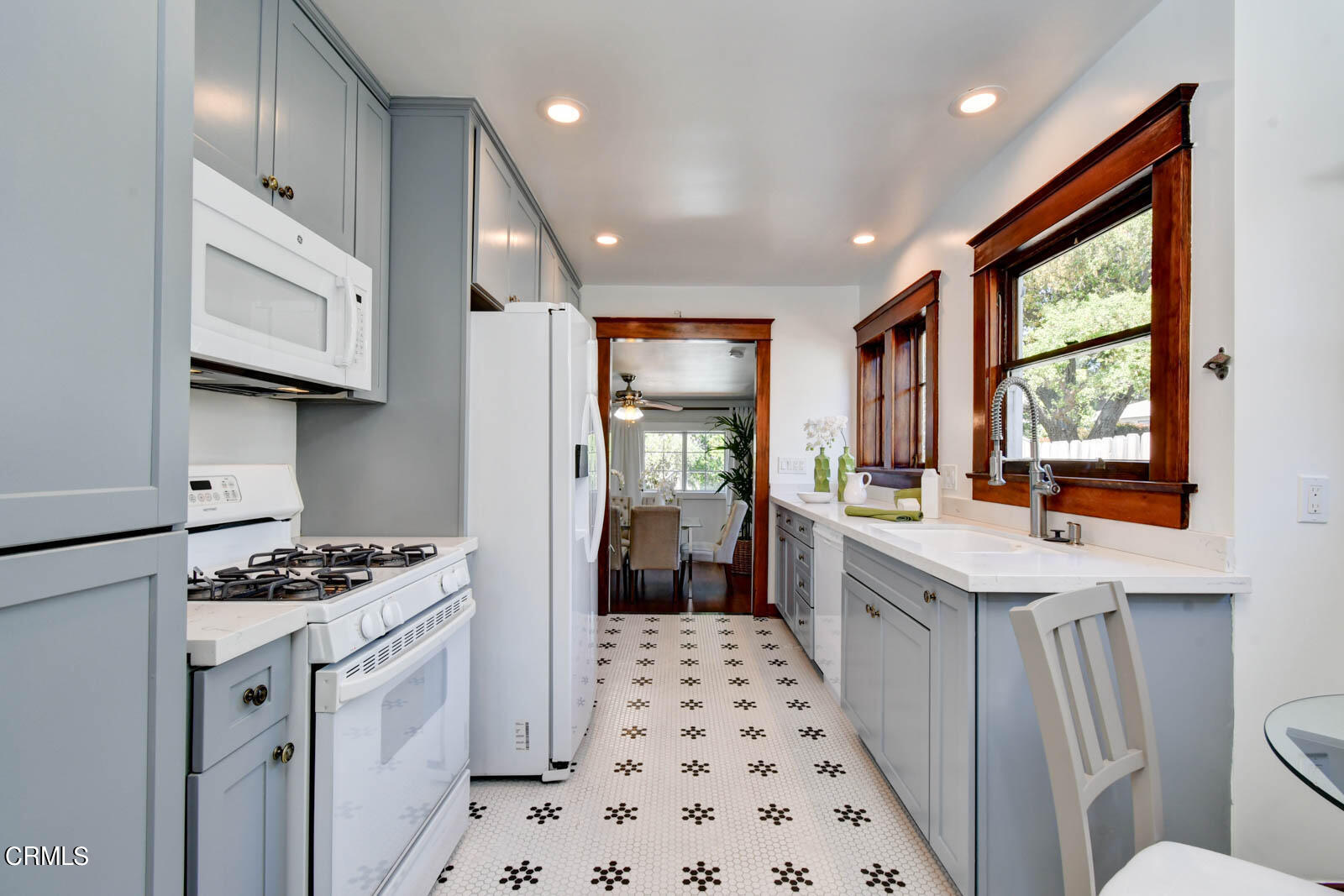 149 Grand Avenue Monrovia, CA 91016 - Photo 9 of 50 a kitchen with stainless steel appliances a sink a stove a refrigerator and cabinets