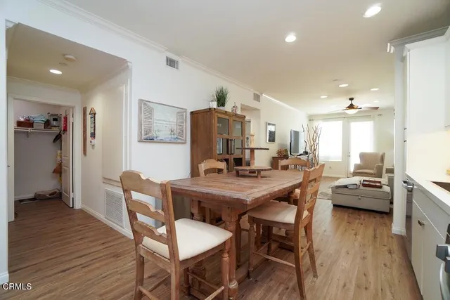 a view of a dining room with furniture and wooden floor