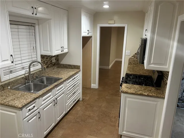 a kitchen with a sink stove and refrigerator