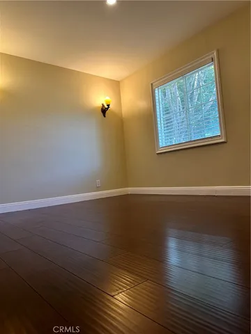 a bathroom with a granite countertop sink a mirror and a bathtub