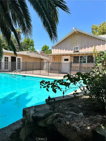 a view of a utility room with wooden floor and cabinet