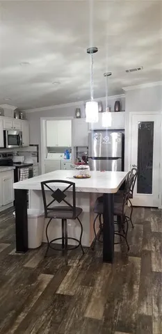 a kitchen with a table and chairs in it