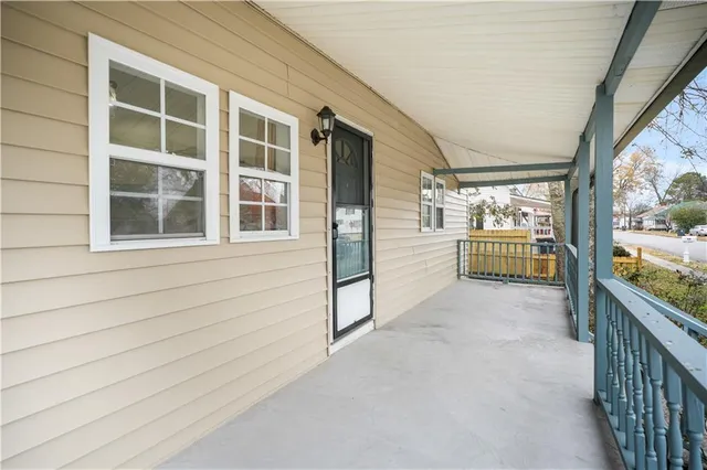 a view of empty room with wooden floor and windows